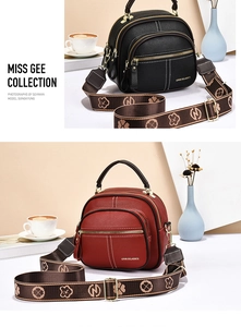 Detail view of lychee pattern leather bags with wide floral strap and gold zippers