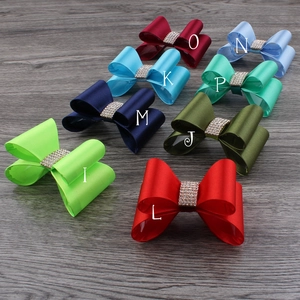 Flat lay of colorful chiffon flower hair clips with sparkling rhinestone centers