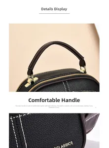 Detail of black litchi grain leather bag with brown handles and contrast stitching