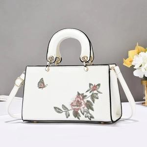 White leather handbag with floral embroidery and gold hardware for women