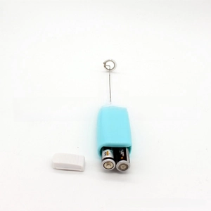 Detail view of the open battery compartment of the mini electric milk frother and mixer