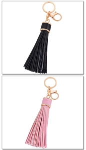 Detail of leather tassel keychains in black and pink with gold zinc alloy lobster clasps