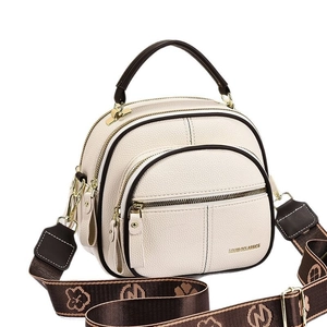 Minimalist beige crossbody bag with three zipper layers and wide jacquard strap