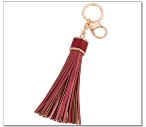 Detail of burgundy leather tassel keychain with gold lobster clasp and zinc alloy ring