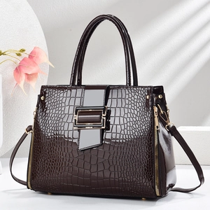 Deep brown crocodile embossed patent leather handbag with gold metal buckle and strap