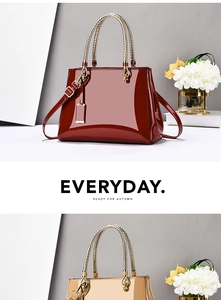 Detail of glossy patent leather tote bags with metal woven handles in burgundy and champagne