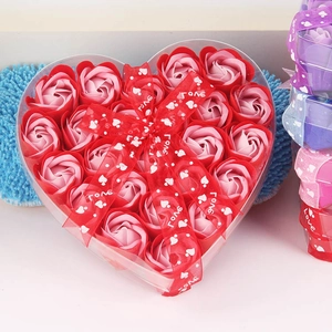 Macro shot of heart-shaped gift box with soap roses and red love ribbon detail