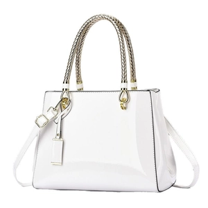 White patent leather tote bag with gold woven handles and adjustable shoulder strap