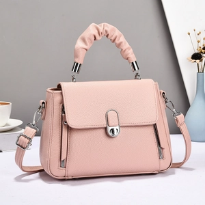Pale pink lychee grain leather handbag with ruched handle and adjustable shoulder strap