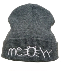 Detailed view of gray knit beanie featuring white Meow embroidery with cat face design