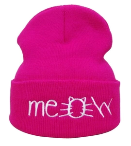 Detail of white Meow embroidery and cat pattern on bright pink knitted beanie hat