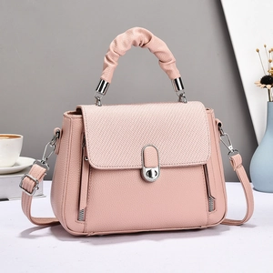 Pastel pink macaron-style handbag with woven flap and textured ruched handle