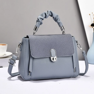 Elegant Morandi blue leather handbag with woven flap and decorative pleated top handle
