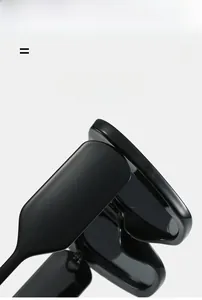 Close-up of flexible hinge on oversized black cat eye sunglasses with elastic frames