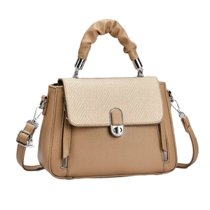 Tan macaron patchwork crossbody bag with lychee texture leather and woven flap detail