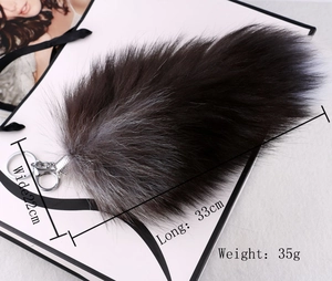 Detail view of a large grey faux fox fur keychain showing dimensions 33cm by 22cm