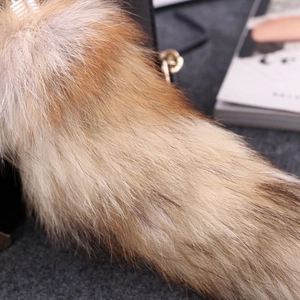 Macro shot of natural fox fur texture in gradient tan and brown for keychain accessories