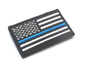 Detailed view of Thin Blue Line USA flag embroidered patch with tactical hook backing