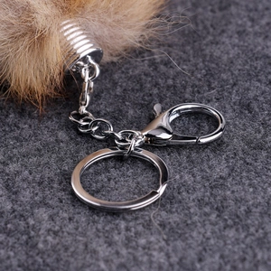 Detail of silver metal keychain accessories with a lobster clasp and chain for fur pendant