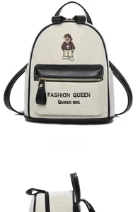 Detailed embroidery of a teddy bear and fashion text on a canvas mini backpack