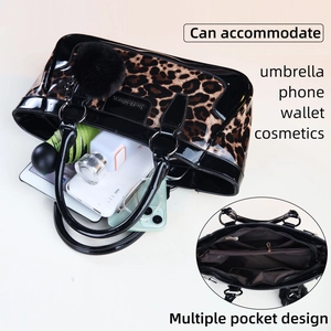 Large leopard print patent leather tote bag with multiple pockets and pompom charm