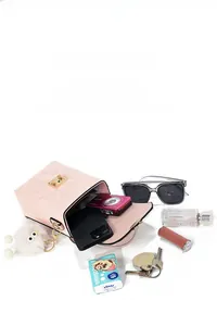 Pink snakeskin pattern crossbody bag showing internal capacity with daily essentials