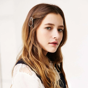 Golden hollow pineapple hair clip hairpin accessory for women shown on model