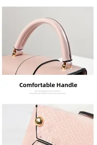 Detail view of pink snakeskin pattern bag showing sturdy handle and gold metal feet studs