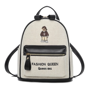 Mini canvas backpack for women with bear embroidery and fashion queen text on white background