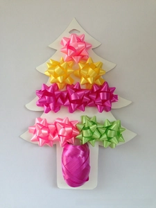 Mini 1-inch star bows and ribbon set on a white tree-shaped card for gift wrapping
