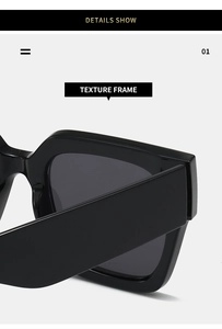 Détail macro de la monture de lunettes de soleil carrée noire montrant la texture lisse
