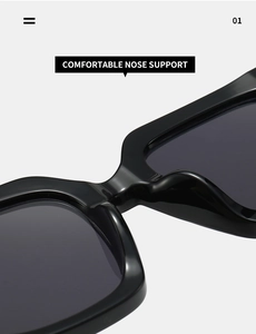 Détail du support de nez intégré sur des lunettes de soleil carrées noires élégantes