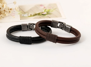 Close-up of vintage braided leather bracelets in black and brown with metal buckles