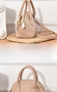 Détail du sac à main en cuir grainé beige montrant la texture et le fermoir doré