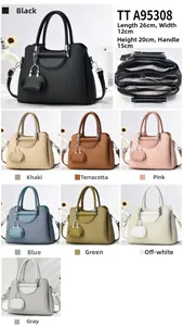 Detailed view of women's woven handbags in eight colors with removable straps and mini charms