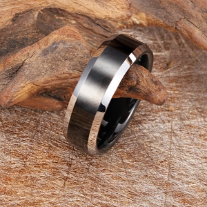 Men's black tungsten steel ring with silver bevel edge on natural wood background