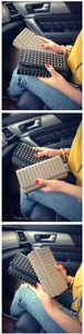 Detail of long punk wallets featuring golden rivets on black and beige leather surfaces