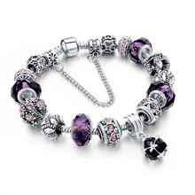Detail of beaded snake chain bracelet with purple crystals and sparkling safety chain