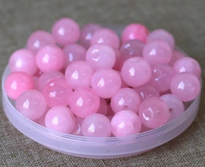 Macro view of translucent pink quartz beads with pre-drilled holes for jewelry DIY