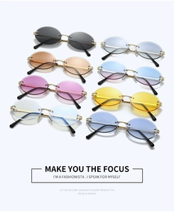Detailed view of rimless oval sunglasses showing engraved gold metal hinges and colorful lenses