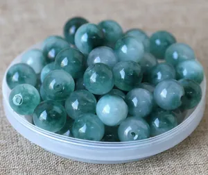Macro detail of natural jadeite loose beads with green veins for DIY jewelry making