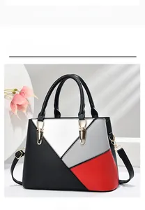 Detail of colorful geometric leather handbag with gold hardware and top handle