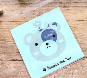 Detail of transparent OPP self-adhesive cookie bag with a cute blue cartoon bear card
