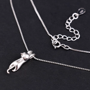 Macro shot of S925 sterling silver playful cat pendant with adjustable box chain