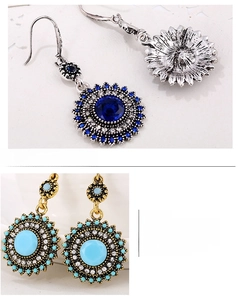 Close-up of vintage sunflower earrings with blue stones and intricate metal detailing
