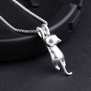 Macro shot of a matte S925 sterling silver playful cat pendant on a box chain