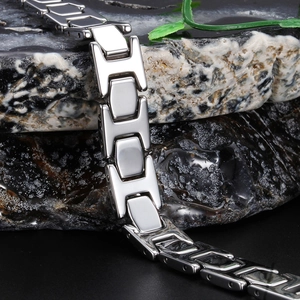 Polished silver tungsten H-link men's bracelet displayed on dark mineral stone background