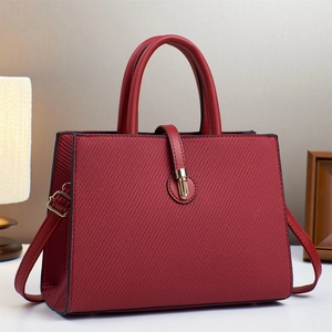 Elegant wine red textured leather handbag with gold metal clasp and dual handles