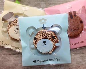 Macro shot of bear, dog, and rabbit cartoon patterns on translucent food packaging bags