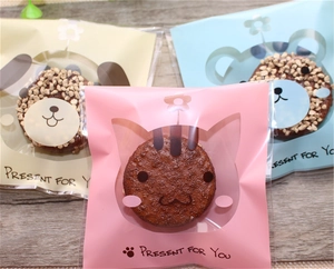 Detail of three translucent self-adhesive cookie bags with cute animal cartoon designs